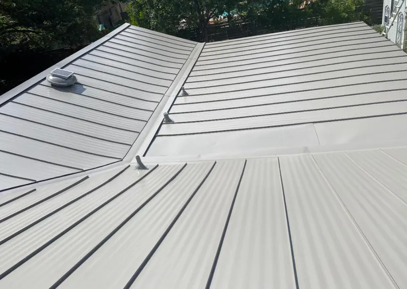 Solar attic fan installed on a metal roof for Roof Ventilation in Hollymead